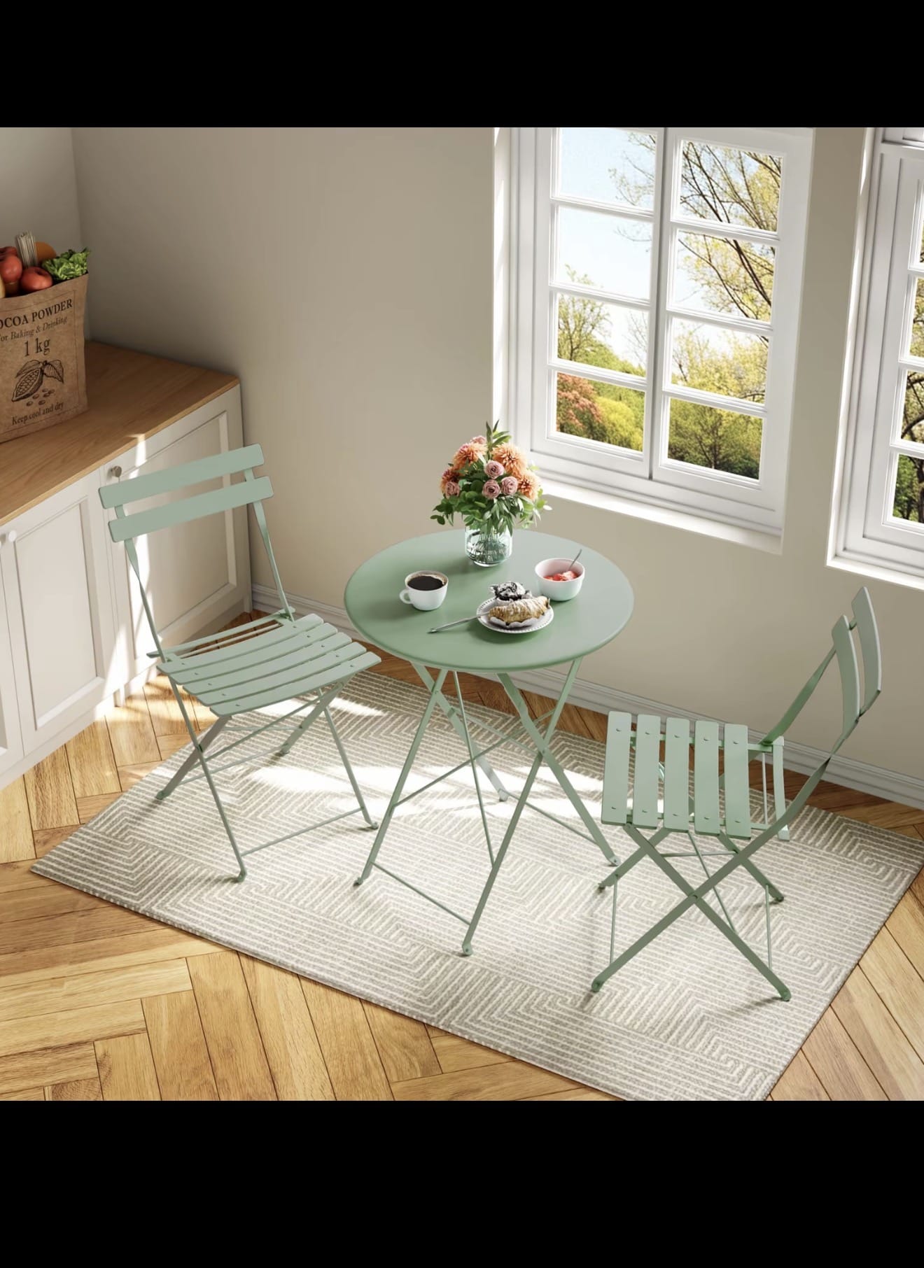 Pink folding metal bistro set indoors by window